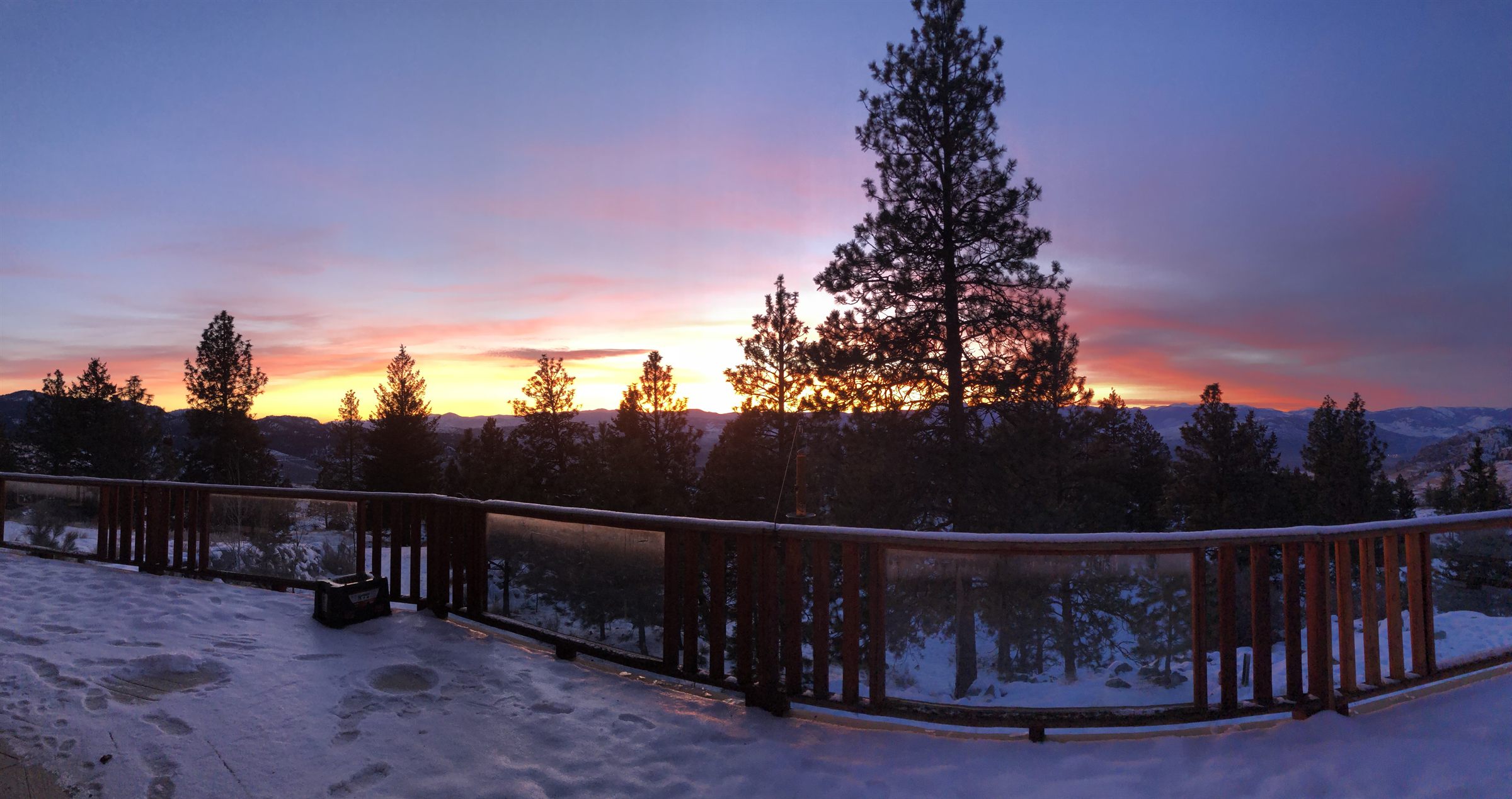 Panoramic sunset from the deck over the valley in winter.