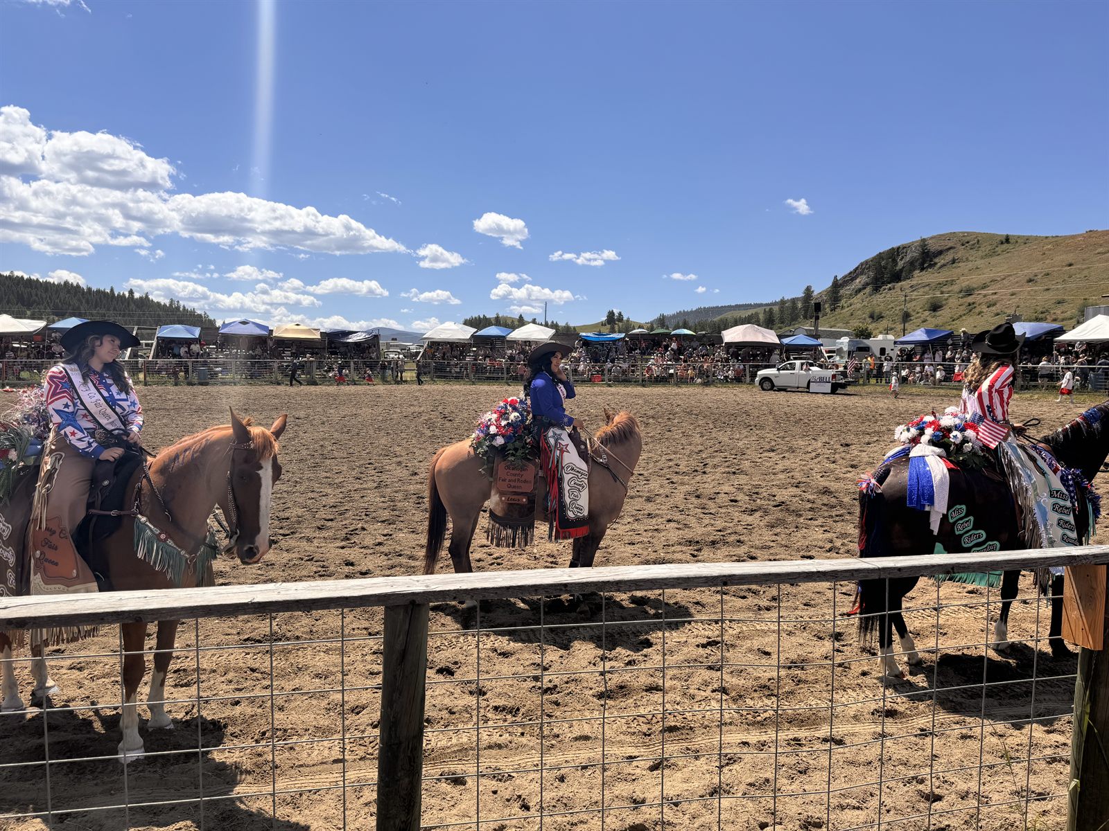 Riders at a local rodeo on a summer day.